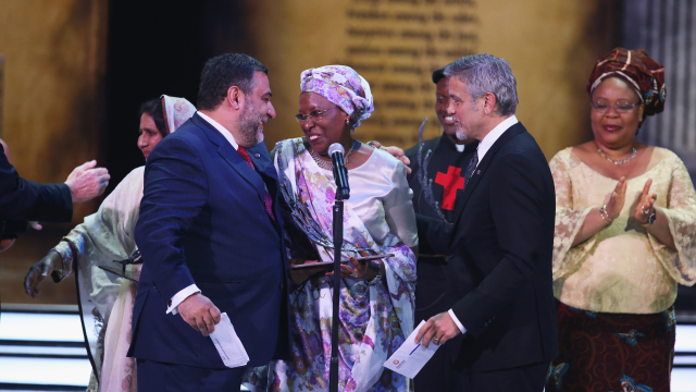 Marguerite Barankitse accepts the inaugural Aurora Prize for Awakening Humanity from George Clooney