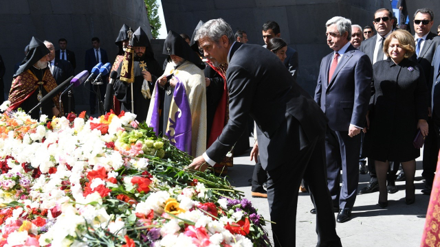 George Clooney lays a flower at the Armenian Genocide Memorial